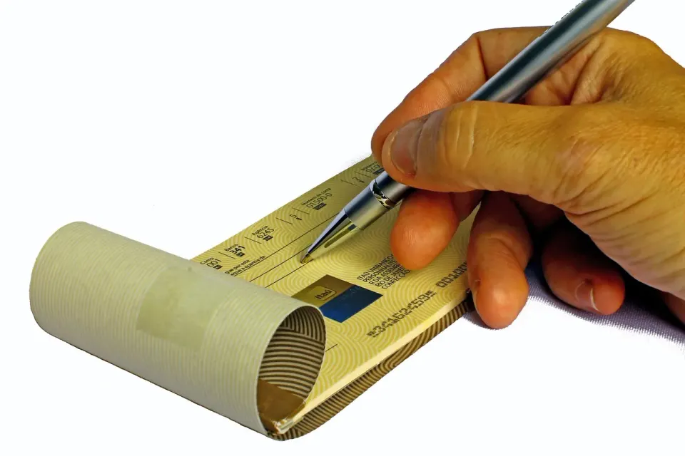 A checkbook and pen ready for writing a paper check