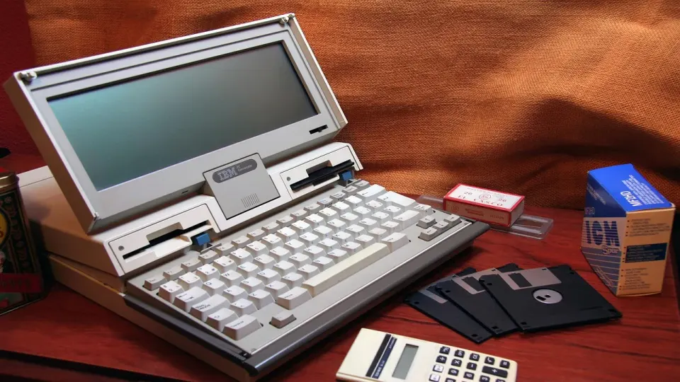 A vintage portable computer with a small screen, the kind of aging hardware offices keep running too long